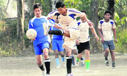 Players in action in a match during the 1st Late Neelratan Kashyap Memorial District Level Football Tournament in Dehradun on Tuesday. A Tribune photograph 