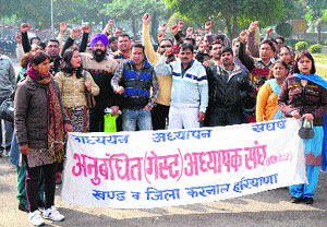 Guest teachers take out a protest march in Karnal on Tuesday, demanding the regularisation on their services
