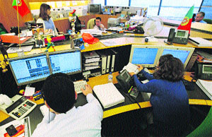 Traders work at a bank in Lisbon on Wednesday. Portugal sold all 2.5 billion euros of Treasury bills on offer on Wednesday and yields fell sharply, lifting chances the bailed-out country will stage a successful return to the longer-term bond market this year.