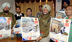 Senior Superintendent of Police Ravcharan Brar (centre) releases the calendar aimed at creating awareness on traffic rules at a press conference held in the city on Wednesday