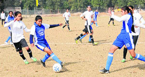 Girls in action during a football match at Panjab University in Chandigarh on Wednesday. 