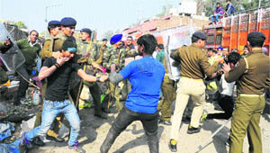 Protesters clash with policemen during an anti-encroachmet drive in Sector 26, Chandigarh, on Wednesday.