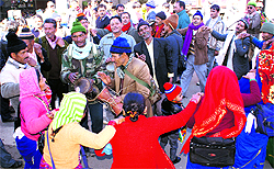 Men and women play chachari at the Uttarayani Mela at Bageshwar