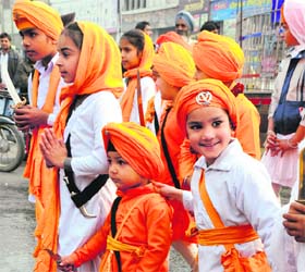 Children participate in a nagar kirtan procession to mark the birth anniversary of Guru Gobind Singh in Karnal on Wednesday