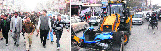 Mayor Sunil Jyoti and police officials lead a flag march to remove encroadhments in Jalandhar on Wednesday; and (right) MC staff remove encroachments during the flag march. Tribune photos