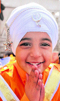 A child participates in a nagar kirtan organised to celebrate the birth anniversary of 10th Sikh guru, Guru Gobind Singh, in Jammu on Wednesday.
