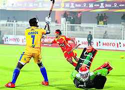 Punjabs Ignace Tirkey and goalkeeper Jaap Stockmann attempt to make a save during their loss to Ranchi Rhinos in Jalandhar