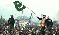 A supporter of cleric Allama Tahirul Qadri waves a Pakistani flag on the third day of protests in Islamabad on Wednesday.  Reuters 