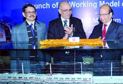 DMRC Managing Director Mangu Singh unveils a working model of a train at Delhi Metro Museum at the Patel Chowk station in New Delhi on Thursday.