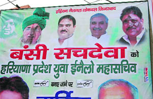  A hoarding showing OP Chautalas and Ajay Singhs face blackened in Sirsa. 