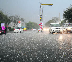 Vehicles plying during the hailstorm in Karnal on Thursday afternoon.
