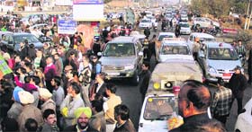 Commuters passing through Maqsudan flyover caught in a traffic jam as BJP workers welcome new party president Kamal Sharma on his arrival in Jalandhar on Thursday