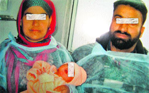The couple who adopted the abandoned infant at GB Pant Hospital in Srinagar on Thursday. 