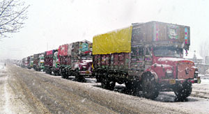 A long queue of stranded trucks due to heavy snowfall at lower Munda on the Srinagar-Jammu National Highway on Thursday. 