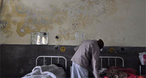A family member attends to a patient at the emergency ward of the Civil Hospital.