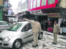 A policeman manages traffic on Mall Road in Mussoorie on Friday.