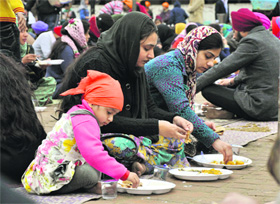 Devotees partake of langar at a gurdwara on the birth anniversary of Guru Gobind Singh in Jalandhar on Friday.
