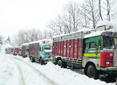 Following heavy snowfall, trucks are stranded near the Jawahar tunnel on the Jammu-Srinagar National Highway on Friday.