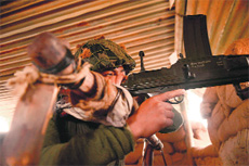 A BSF soldier keeps vigil at an outpost along the India-Pakistan border in Suchetgarh on Friday. 