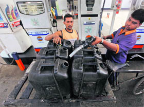 A worker filling a jerrycan at a fuel station in Kolkata. Shares in state-run oil firms surged for a second day on Friday, with ONGC gaining as much as 12.9% to add around US $6 billion in market value, after a government diesel price hike was seen reducing their subsidy burden. 