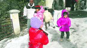 Children play with snow.