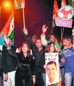 Celebrate outside the AICC headquarters in New Delhi on Saturday.