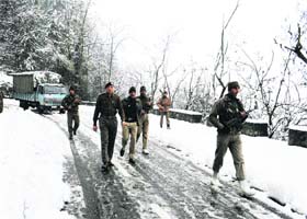 CRPF personnel patrol the snow-covered road of historic Shankaracharya temple in Srinagar on Saturday