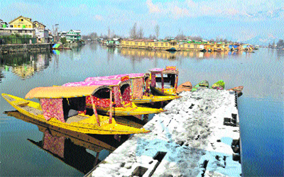Shikaras moored to a jetty at the Dal Lake in Srinagar on Saturday. 