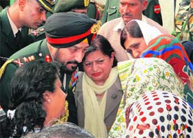 Reaching out: Army Chief Gen Bikram Singh and his wife with the family of Lance Naik Hemraj, killed by Pakistani infiltrators at the LoC
