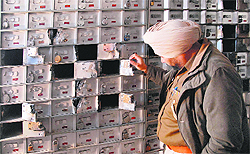 A policeman inspects lockers at Punjab and Sind Bank, Reru Chowk, in Jalandhar on Saturday