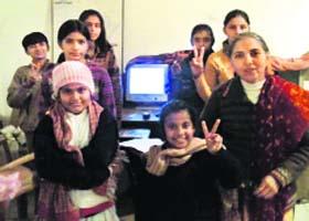 GUIDING LIGHT: Dr Ratna Bharti with a group of village girls learning computer applications