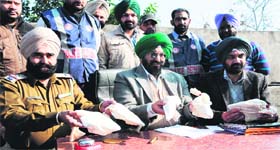 Police officials show the seized weapons from the accused in Amritsar on Sunday