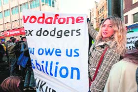 A woman protesting in London against alleged tax evasion by Vodafone