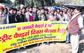 Small traders hold a march demanding implementation of vendors policy at Shaheed Park in Haridwar on Sunday.