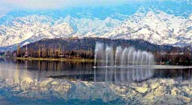 The Zabarwan mountain range is reflected in the waters of the Dal Lake in Srinagar on Sunday.