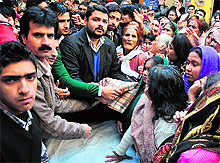 Pradesh Youth Congress vice-president Pranav Shagotra distributes winter material among the distressed persons in Jammu on Sunday