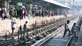 Ignoring their safety, people cross railway lines at the Jalandhar railway station.