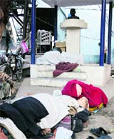 The area near Mahatma Gandhi's statue outside the MC's Zone A office is being used for sleeping purpose in Ludhiana on Sunday.