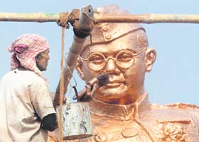 Saluting the hero: A worker paints Netaji Subhas Chandra Bose's bronze statue ahead of his 116th birth anniversary celebrations (January 23) in Kolkata on Sunday