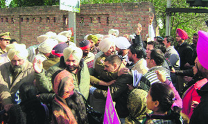 Members of the teachers union try to break a police cordon in Sangrur