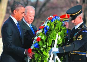US President Barack Obama and Vice-President Joe Biden at the Tomb of the Unknowns at Arlington National Cemetery in Arlington on Sunday