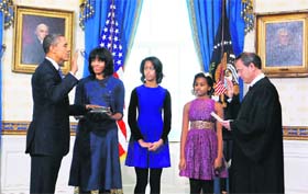 President Barack Obama is sworn-in by Chief Justice John Roberts (R) in the Blue Room of the White House in Washington on Sunday