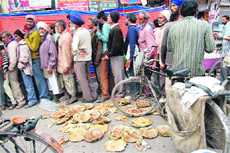 Plates and food left at a langar site on Lawrence Road in Amritsar.
