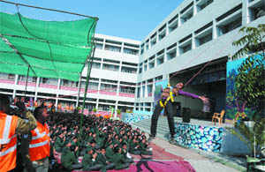 A member of the National Disaster Response Force (NDRF) performs rescue drill at the St. Xaviers School in Bathinda on Monday.