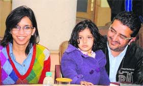 Three-year-old Harmeini with her parents at a press conference in Chandigarh on Monday.
