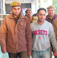 Accused Ravinder Gill being produced in a court in Panchkula on Monday.