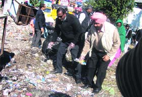 Dehradun District Magistrate BVRC Purushottam leads the Clean Doon campaign by picking up garbage in Dehradun on Monday