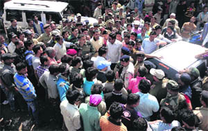 People block taffic to demand repair of the National Highway No. 9 in Pithoragarh on Monday.