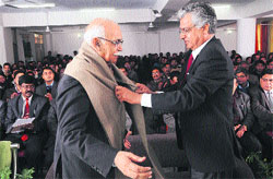 Prof Furqan Qamar, Vice-Chancellor, Central University, honours Prof BN Goswamy on the foundation day of CUHP at Shahpur on Monday. Photo: Ashok Raina