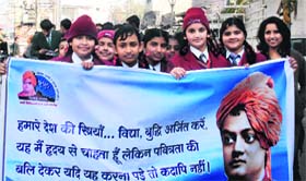 Students of various schools take part in a procession in connection with the 150th birth anniversary celebrations of Swami Vivekanand in Nakodar